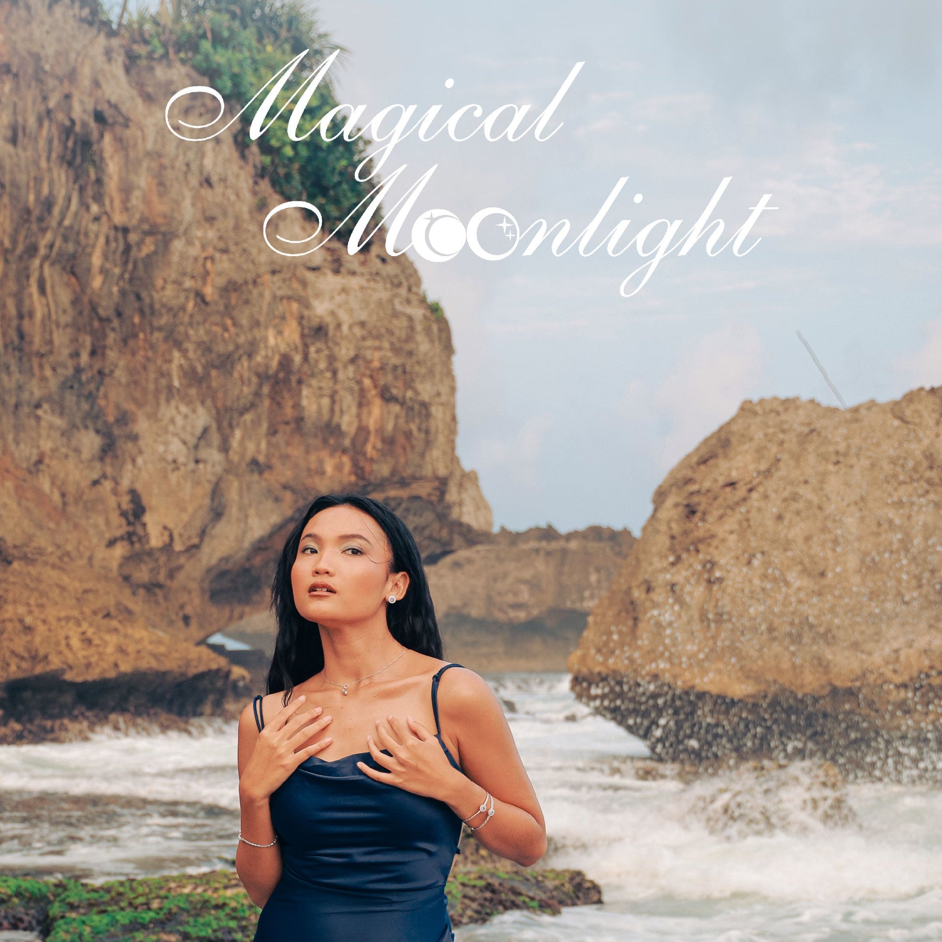 Woman in a dark blue dress standing on a rocky beach with the text 'Magical Moonlight'.